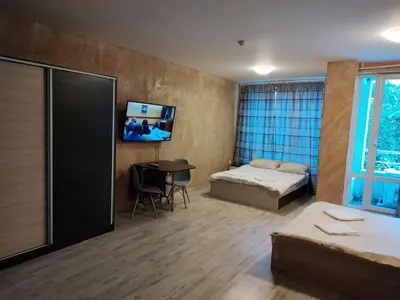 a room with a bed and a desk and a tv at Colonel apartment 957 in Sofia