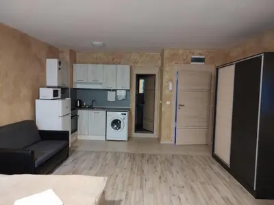 a living room with a couch and a kitchen at Colonel apartment 957 in Sofia