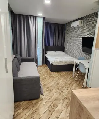 a room with a bed and a couch and a table at Colonel apartment Relax in Sofia
