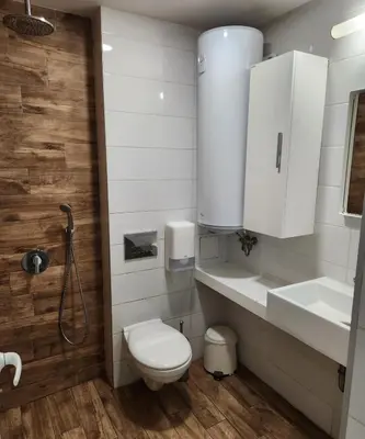 a bathroom with a toilet and a sink and a shower at Colonel apartment Relax in Sofia