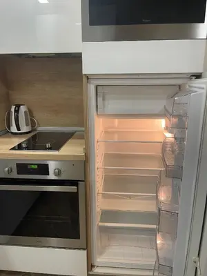 an empty refrigerator with its door open in a kitchen at Colonel apartment Royal in Sofia