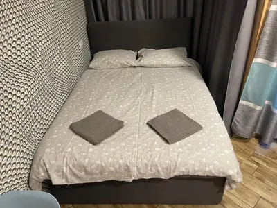 a bed with two pillows on top of it at Colonel apartment Royal in Sofia