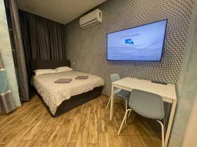 a small room with a bed and a table and a tv at Colonel apartment Select in Sofia