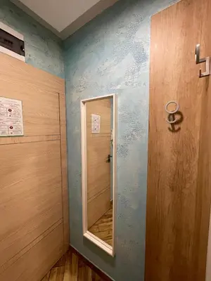 a bathroom with a mirror next to a door at Colonel apartment Select in Sofia