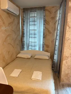 a bedroom with a bed with two towels on it at Colonel apartment 937 in Sofia