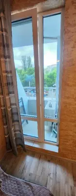 a bedroom with a large window and a balcony at Colonel apartment 941 in Sofia