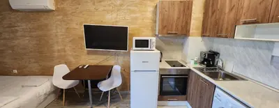 a small kitchen with a table and a microwave at Colonel apartment 941 in Sofia