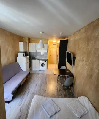 a living room with a couch and a desk with a computer at Colonel apartment 953 in Sofia