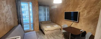 a small room with a small bed and a television at Colonel apartment 954 in Sofia
