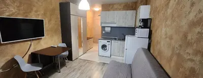 a living room with a couch and a tv and a kitchen at Colonel apartment 954 in Sofia