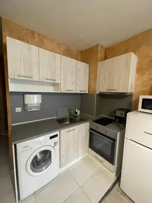 a kitchen with a washing machine and a washer at Colonel apartment 954 in Sofia