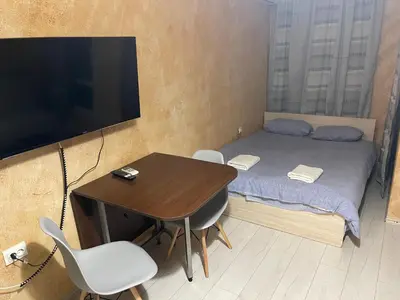 a small room with a bed and a desk with a television at Colonel apartment 955 in Sofia