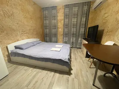 a bedroom with a bed and a table and a television at Colonel apartment 956 in Sofia