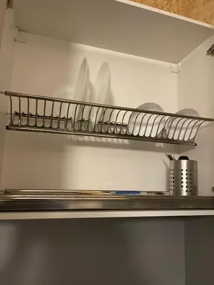a shelf in a refrigerator with plates and utensils at Colonel apartment 956 in Sofia