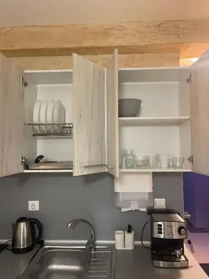 a kitchen with white cabinets and a sink at Colonel apartment 959 in Sofia