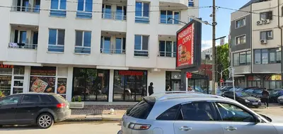 two cars parked on a street in front of a building at Colonel apartment 963 in Sofia