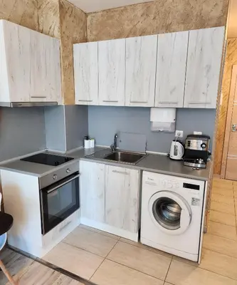 a kitchen with a washing machine and a sink at Colonel apartment 963 in Sofia