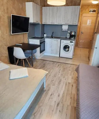 a kitchen with a table and a kitchen with a stove at Colonel apartment 963 in Sofia