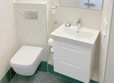 a white bathroom with a toilet and a sink at Orfey Apartment in Sofia