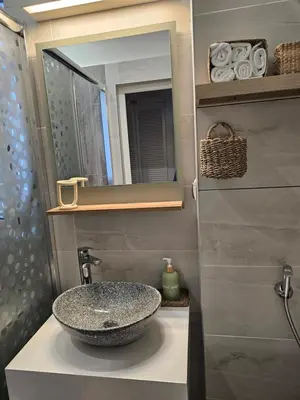 a bathroom with a sink and a mirror at S íRMA Apartment - The Soul of Central Sofia in Sofia