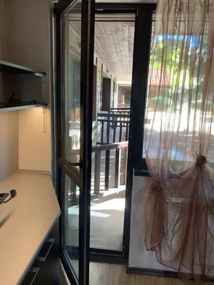 a kitchen with a door open to a porch at 7 apartments in Alexander complex in Bansko