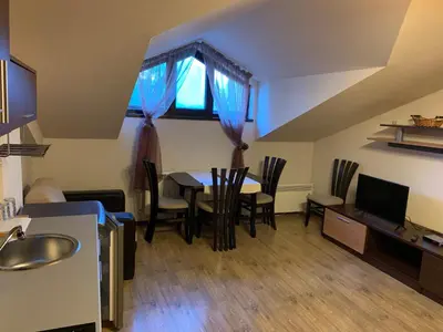 a kitchen and dining room with a table and chairs at 7 apartments in Alexander complex in Bansko