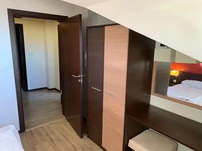 a small bedroom with a bed and a mirror at 7 apartments in Alexander complex in Bansko