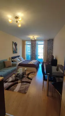 a living room with a bed and a couch at Aspen Valley Studio Apartment Аспен Вали студио апартамент in Razlog