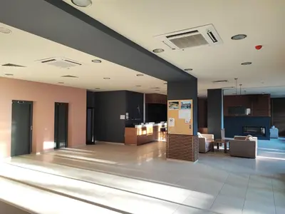a lobby of a building with a living room at Aspen Valley Studio Apartment Аспен Вали студио апартамент in Razlog