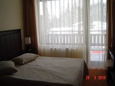 a bedroom with a bed and a large window at Spider House Aparthotel in Pamporovo