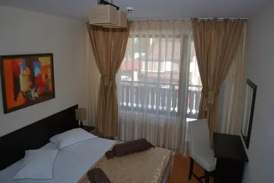a bedroom with a bed and a window at Spider House Aparthotel in Pamporovo