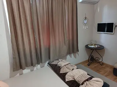a bedroom with a bed with towels on it at Къща за гости Рупите , Guest House Relax Rupite in Rupite