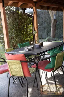a black table and chairs on a patio at Къща за гости Рупите , Guest House Relax Rupite in Rupite