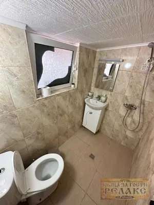 a bathroom with a toilet and a sink at Къща за гости Рупите , Guest House Relax Rupite in Rupite