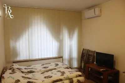 a bedroom with a bed and a television at Bansko Apart in Bansko