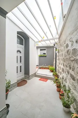 a courtyard with a skylight and potted plants at MARSY in Sandanski