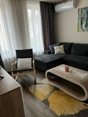 a living room with a couch and a table at MARSY in Sandanski