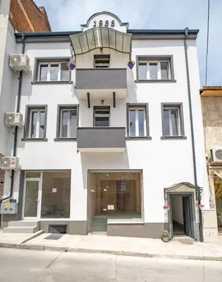an apartment building with a white facade at MARSY in Sandanski