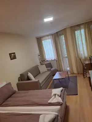 a living room with a couch and a living room with a couch at Family Studio 302, Villa park in Borovets