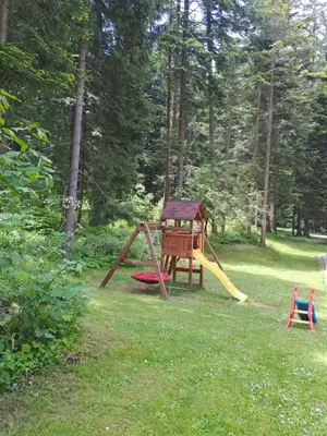 a playground with a slide in the grass at Family Studio 302, Villa park in Borovets