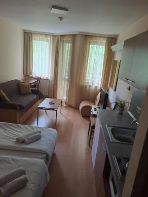 a living room with a bed and a kitchen and a couch at Family Studio 302, Villa park in Borovets