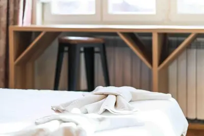 a pile of towels sitting on top of a bed at Heart of the City Center Lux Apartment with View in Sofia