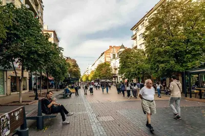 a group of people walking down a city street at Heart of the City Center Lux Apartment with View in Sofia