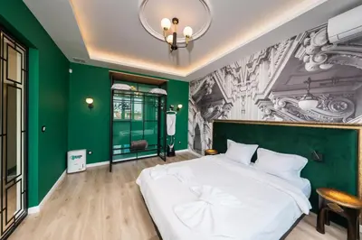 a bedroom with a large white bed and green walls at Heart of the City Center Lux Apartment2 with View in Sofia