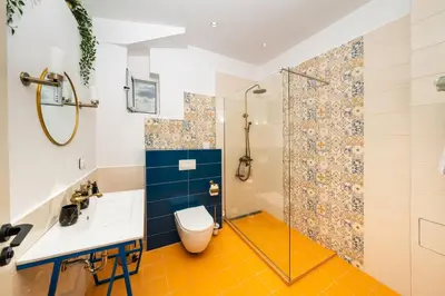 a bathroom with a shower and a toilet and a sink at Heart of the City Center Lux Apartment2 with View in Sofia