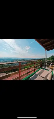 a balcony with chairs and a view of the horizon at Александрова вила 1 in Zlatograd
