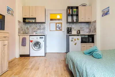 a small kitchen with a washing machine and a washer at The Top Spot - Cute Little Studio in the Center by Flat Mаnager in Sofia