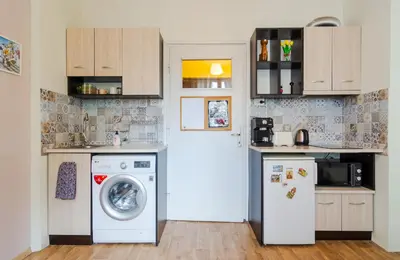 a kitchen with a washing machine and a washer at The Top Spot - Cute Little Studio in the Center by Flat Mаnager in Sofia