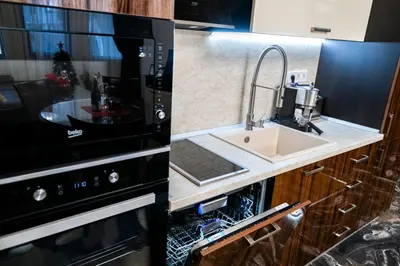 a kitchen with a sink and a microwave at Luxe Apartment Grand Monastery in Pamporovo in Pamporovo