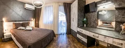 a bedroom with a bed and a large window at Luxe Apartment Grand Monastery in Pamporovo in Pamporovo